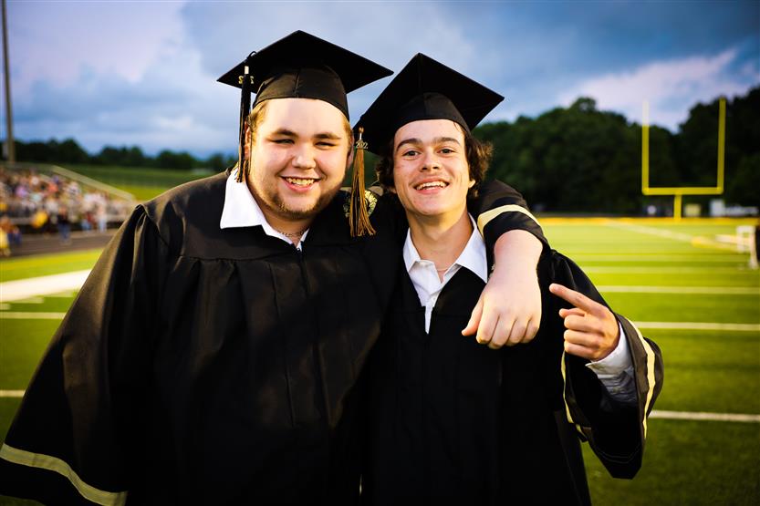 Students graduate on a football field